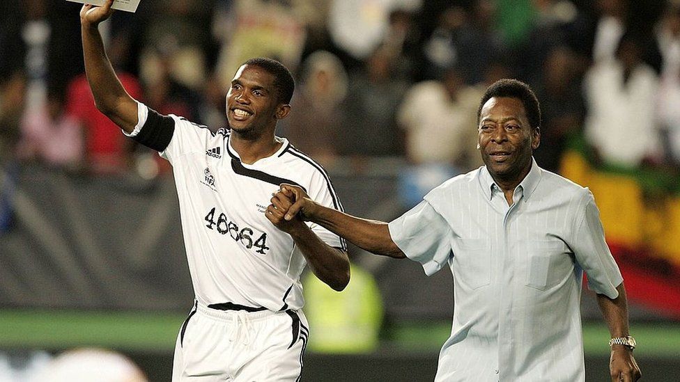 Pele and former Cameroon football star Samuel Etoo greet fans in a tribute match for Nelson Mandela in 2007